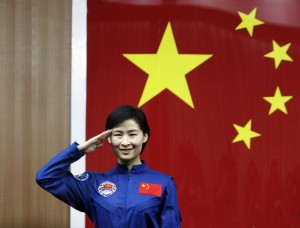 China's first female astronaut Liu Yang salutes during a news conference at Jiuquan Satellite Launch Center